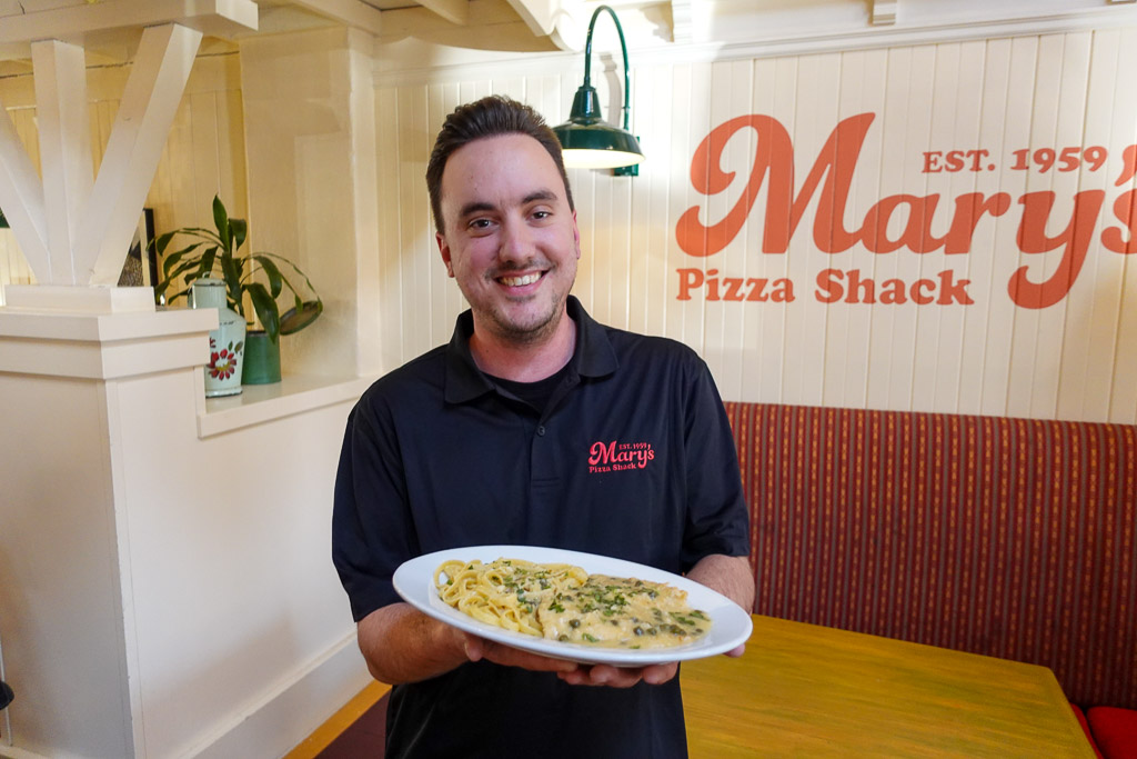 Chicken Piccata dish being presented by a manager of Mary's Pizza Shack.