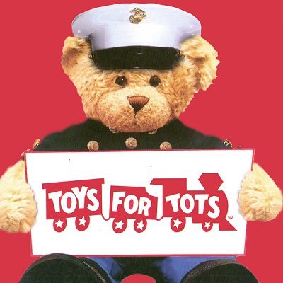 Stuffed bear toy holding Toys for Tots sign